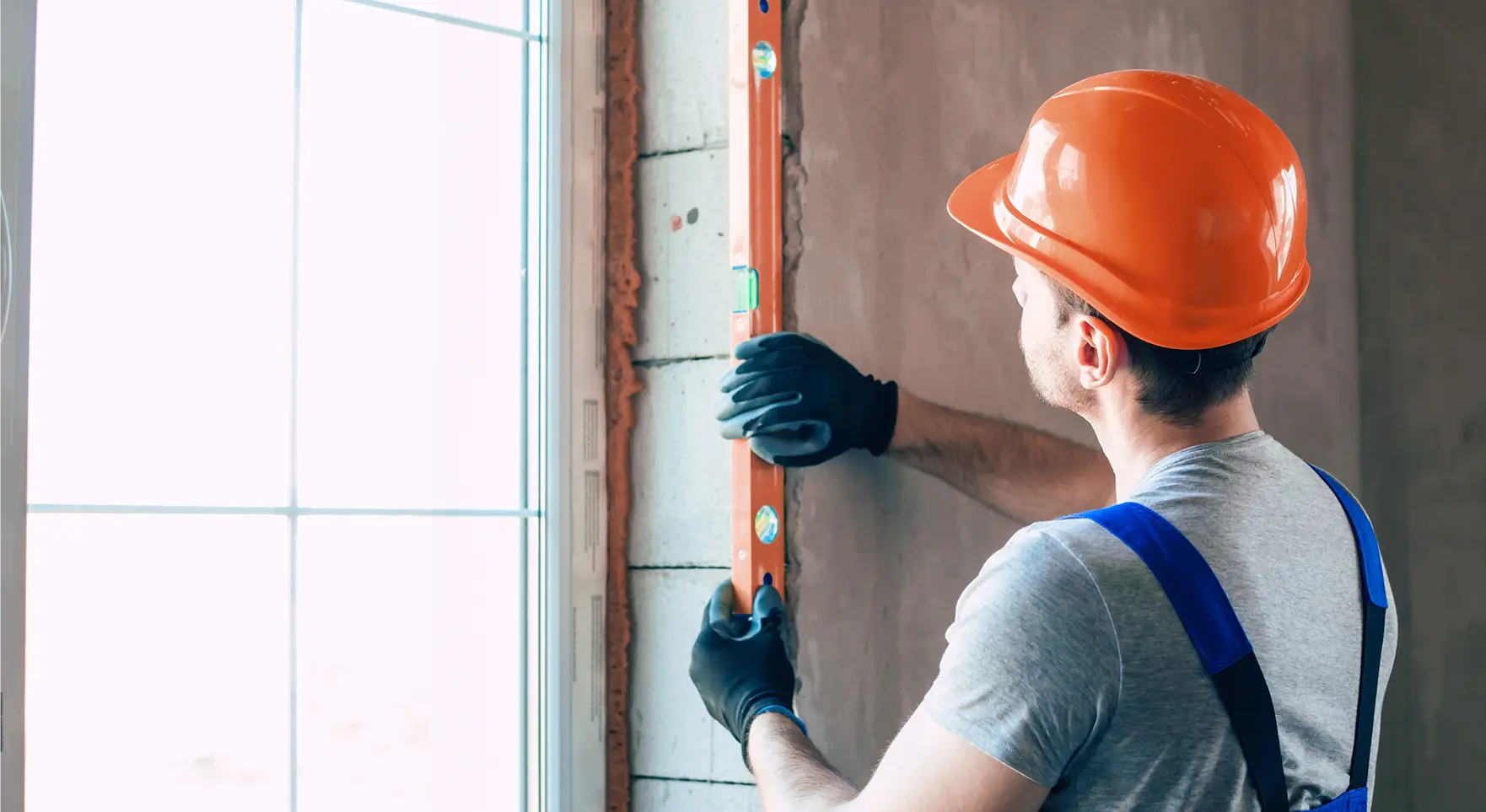 a person measuring wall